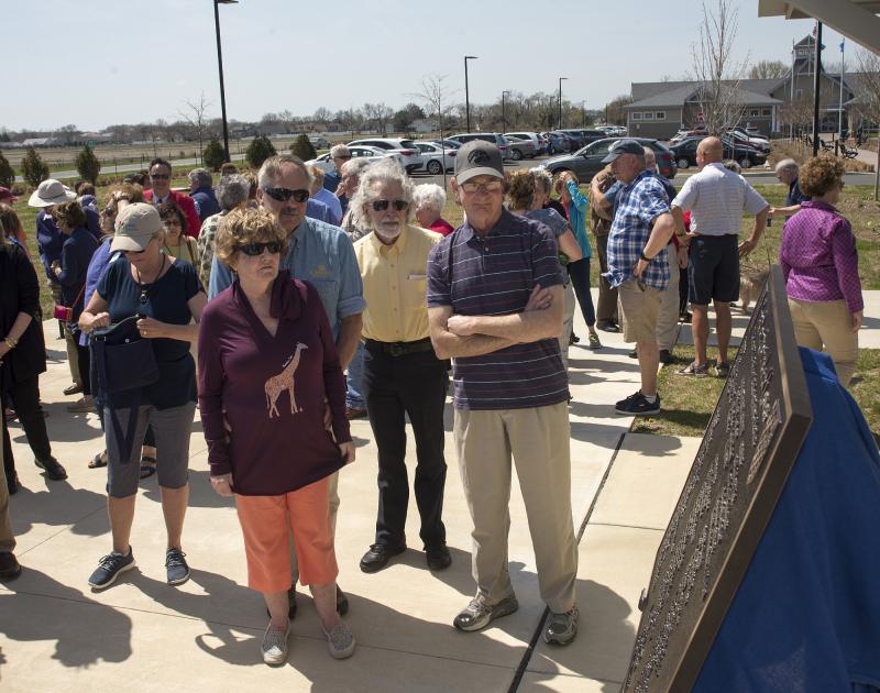 Guests gather to read the plaque.